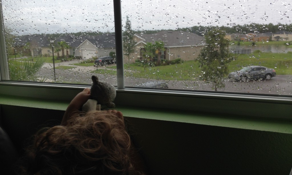 Micah shows Lamby the rain outside.